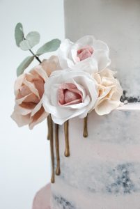 Wafer paper flowers on blush pink wedding cake